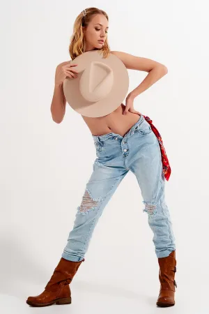 Straight leg distressed jeans with button detail in light blue